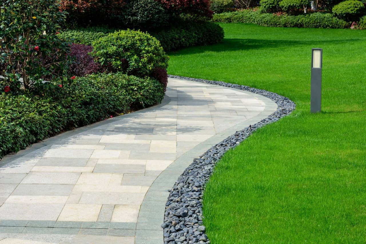 Residential landscape design with fresh garden beds and greenery
