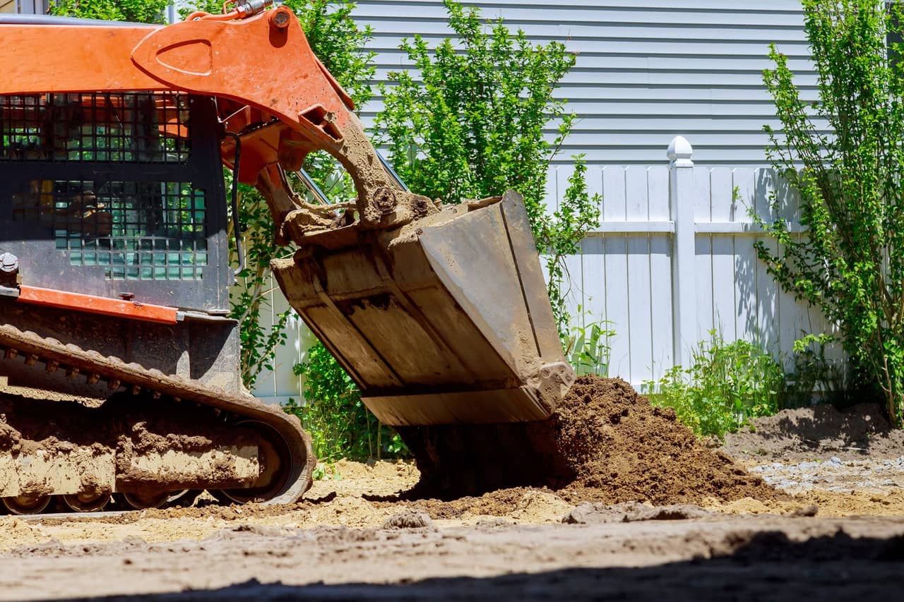 A bulldozer loading dirt into a bucket on a construction site
