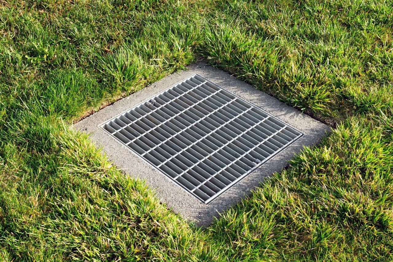Residential drainage solution with stones and landscaping