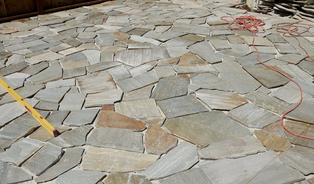 Natural flagstone patio with irregular stone patterns in a garden setting