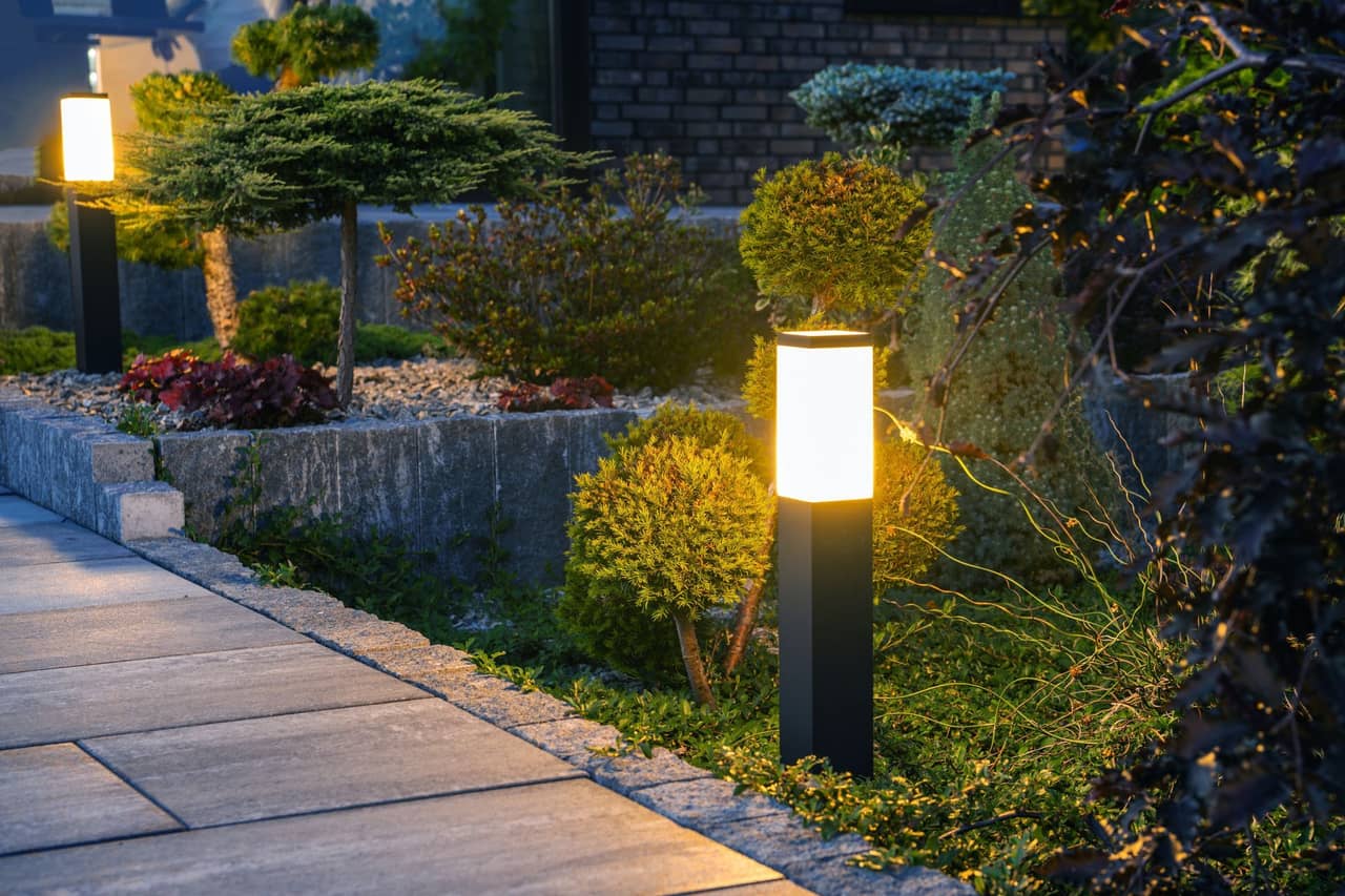 Residential landscape lighting illuminating a garden pathway