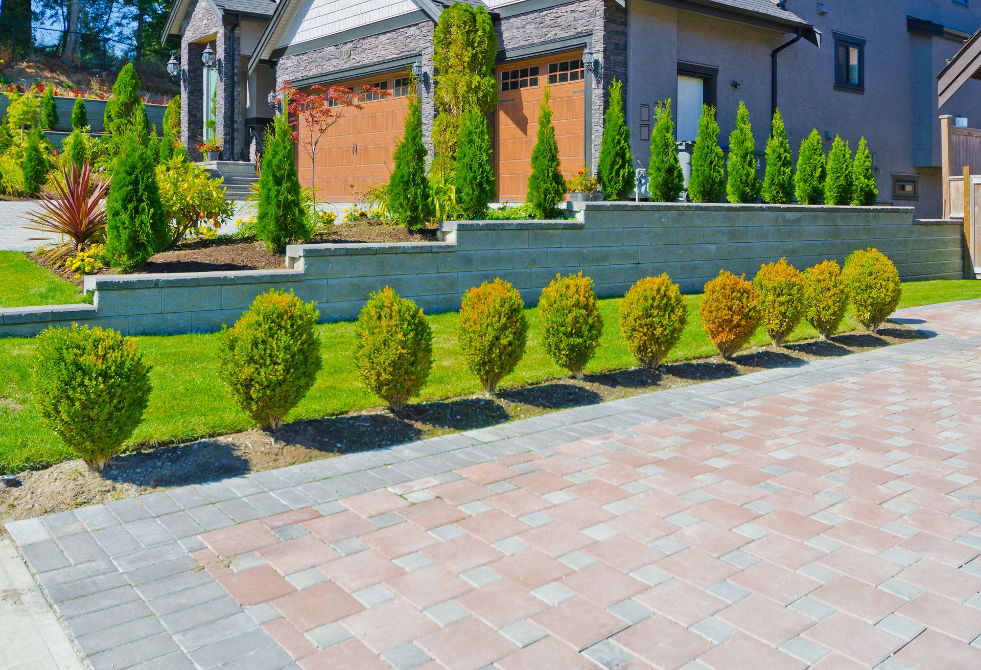 Professional landscaping with lush green lawn and garden beds