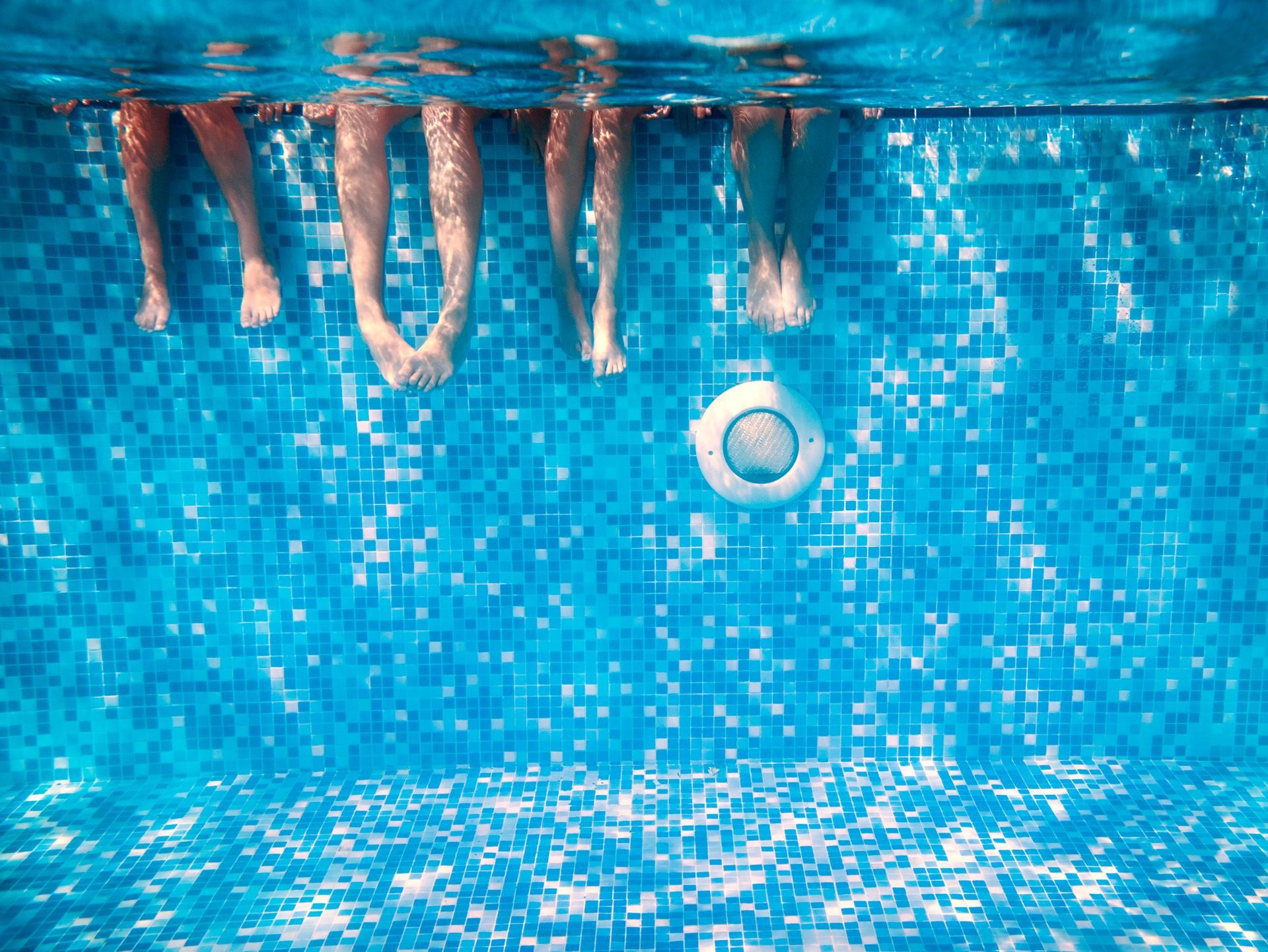 Fiberglass pool installation with landscaped surroundings