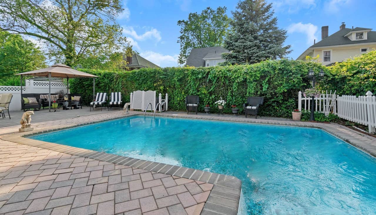 Beautiful fiberglass pool with surrounding landscaping